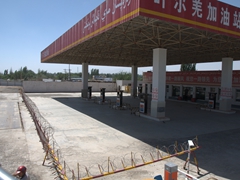 Gas stations in China look like a military checkpoint with barbed wire barricades and a single entry/exit