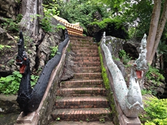 Black and white dragons guarding a reclining Buddha; Mount Phousi