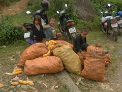 Kids guarding sacks of corn