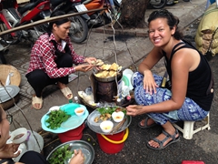 Becky enjoying street food - "nem" or springrolls at 5,000 Dong each; Hanoi