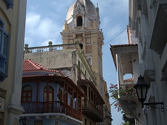 An old city street view of La Catedral's ornate dome