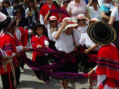 This young girl laughs as she tries to keep her sombrero from falling off; Pase del Niño Viajero