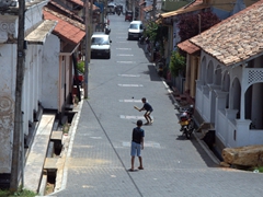 Boys playing street cricket in Galle