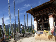 Becky taking a breather amidst a field of prayer flags; Taksang Monastery