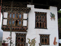 Art work (to include an erect penis on the lower right) on the side of a traditional village home