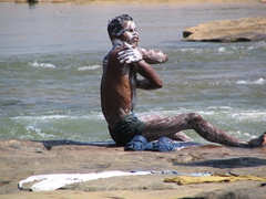 A local takes a quick bath near the Chitrakote waterfall