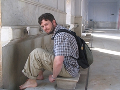 Robby sits on the comfy feet-washing stools, Badshahi Mosque