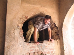 Robby crawling through a passageway that leads to the roof of Asif Khan's Tomb