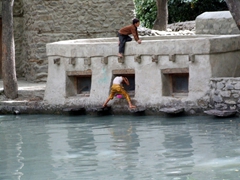 Village boys horsing around old Ganish Village's water tank