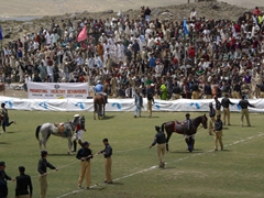 At the end of the match, the police rush the field to hold up the flimsy rope barricade