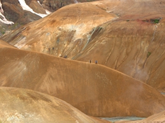 Two hikers look miniscule in comparison to the massive scale of Kerlingarfjöll