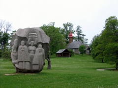 Daina sculpture with the circa 1750 Turaida Church in the background
