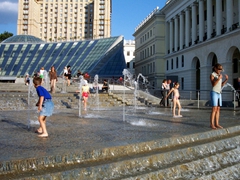 Children beating the summer heat in a fountain at Independence Square; Kiev