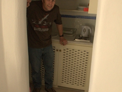 Robby in the kitchen of our cute studio apartment; Old Oia Houses
