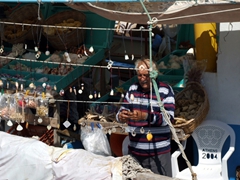 An elderly Greek man selling sea shells and sponges from the sea; Katapola Harbor