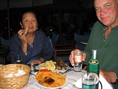 Ann and Bob enjoy their fishermen spaghetti and lamb platter at Mourayio Restaurant in Katapola
