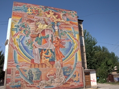 Mosaic mural on the wall of a Soviet style apartment block; Penjikent