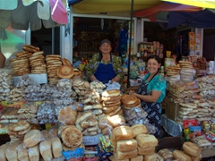 Bread sellers happily pose for a photo; Penjikent Bazaar