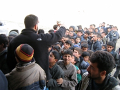 Young boys wait in line patiently to receive brand new jackets and shoes at the Tahi Maskan Orphanage