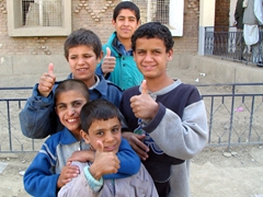 Boys flashing the “thumbs up” sign; Tahi Maskan Orphanage