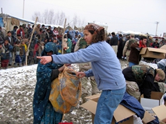 Becky directs an Afghan woman towards the next distribution station
