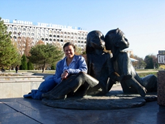 Becky strikes a pose next to two smaller statues of the larger International Friendship Monument (located in front of the Friendship of People's Palace in Tashkent)