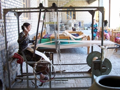 An Uzbek woman creating beautiful tablecloths with her loom