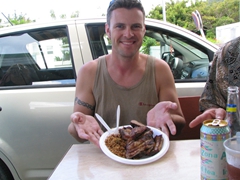 Robby shows off his BBQ meal at Grand Case