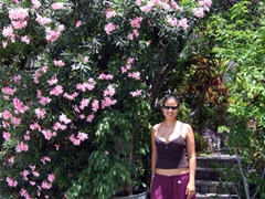 Becky poses next to the flower arch entrance of a St Bart’s home