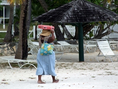 Antiguan woman getting ready to sell her wares; Jolly Beach