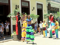 Colorful stilt walkers roam Havana Vieja entertaining tourists and locals alike