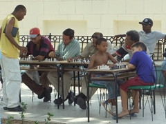 Chess is huge in this outdoor park in Santiago, where a master chess player (in yellow) was competing against multiple opponents