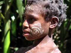 Young child waits to take part in the demonstration of a scarification ceremony