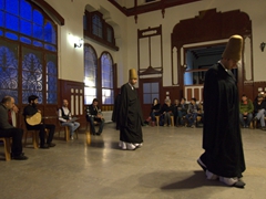 Dervishes walking in at the beginning of the ceremony