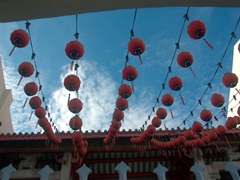 Beautiful red lanterns decorate the courtyard of a temple; Penang