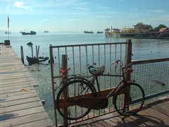 An old bike chained to one of the Clan jetties in Georgetown