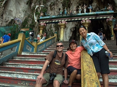 Robby, Ji Sung and Ann smile broadly at the top of the Batu Caves staircase
