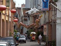 Red Chinese lanterns line a side street in walkable Malacca
