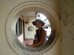 Becky smiles through a circular window common in many of the shophouses in Malacca