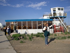 Frances smiles as she points how how tiny Dalenzodgad airport is; Gobi Desert