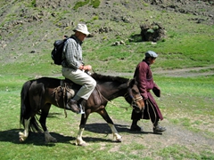 Bob attempts to get comfortable sitting astride a Mongolian saddle; Gurvansaikhan National Park