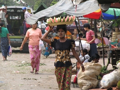 A woman selling sliced watermelon; Mandalay