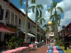 A tree-lined pedestrian Bussorah Street leading towards the Sultan Mosque, one of Singapore's most impressive religious buildings
