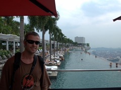 Robby poses next to the world's most photographed swimming pool, an infinity pool located on the 55th floor of Marina Bay Sands, overlooking the city