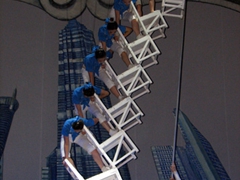 Performers precariously stack chairs on top of each other; Shanghai Center Theater