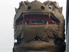 This massive dragon boat pulled up along side our cruise line