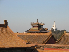 Rooftops of the Forbidden City with a stupa in the background