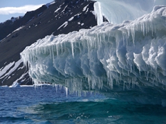 Iceberg dripping with hundreds of icicles; Devil Island in the background