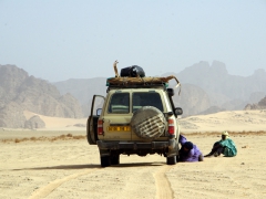 Abdallah checking our 4x4's tires for punctures; Tikobawhen
