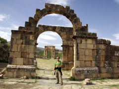 Robby standing in front of an archway leading to Severan Forum; Djemila
